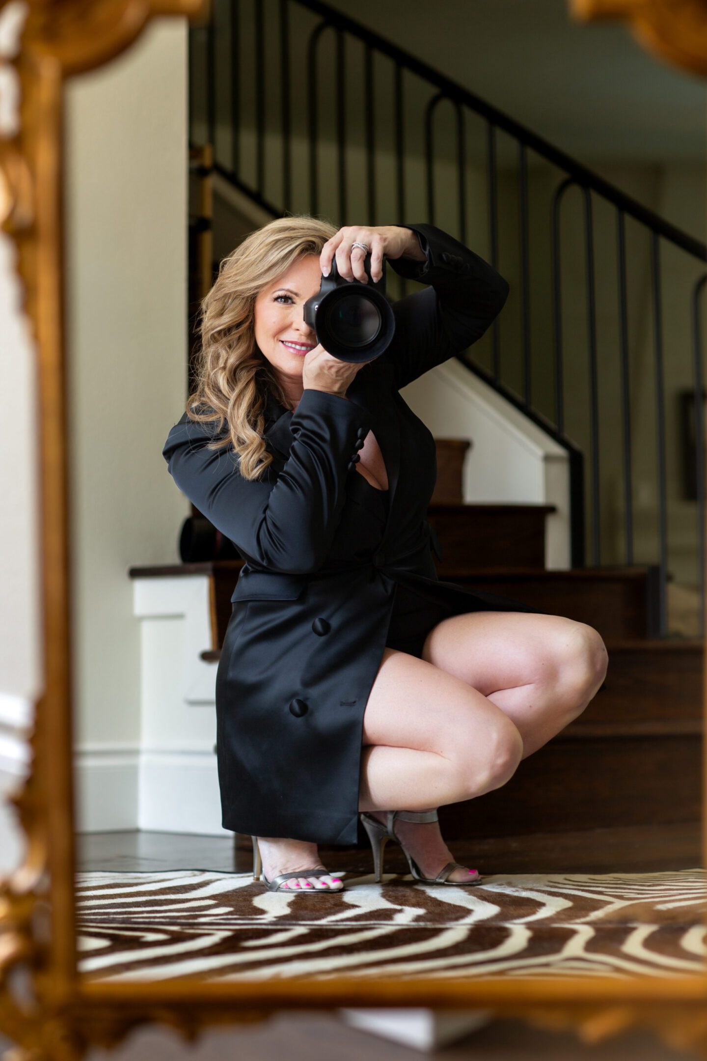 Woman photographing herself in mirror reflection.